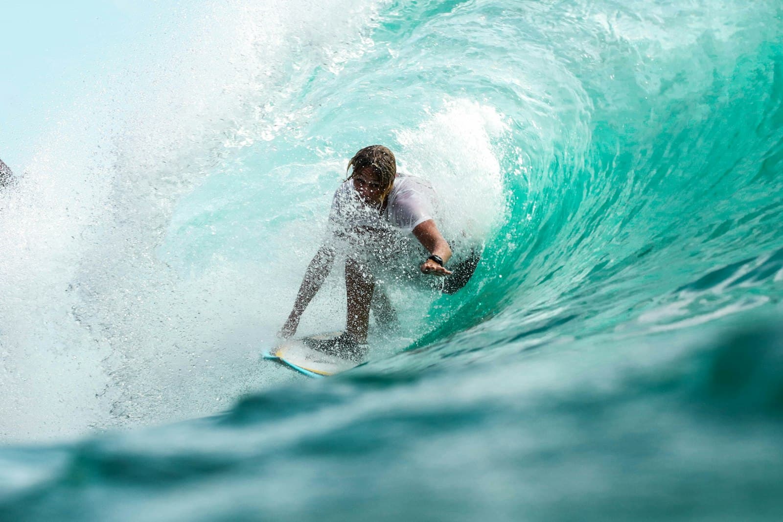 Surfer sitting on a board in clear water