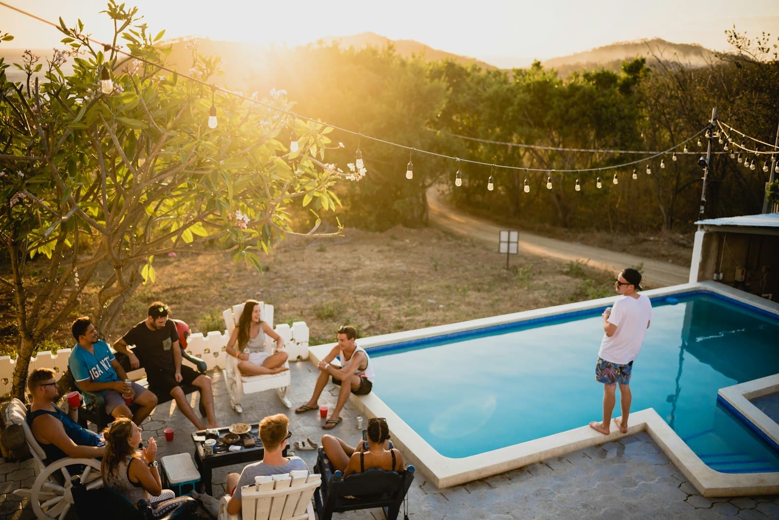 Friends toasting drinks by the pool