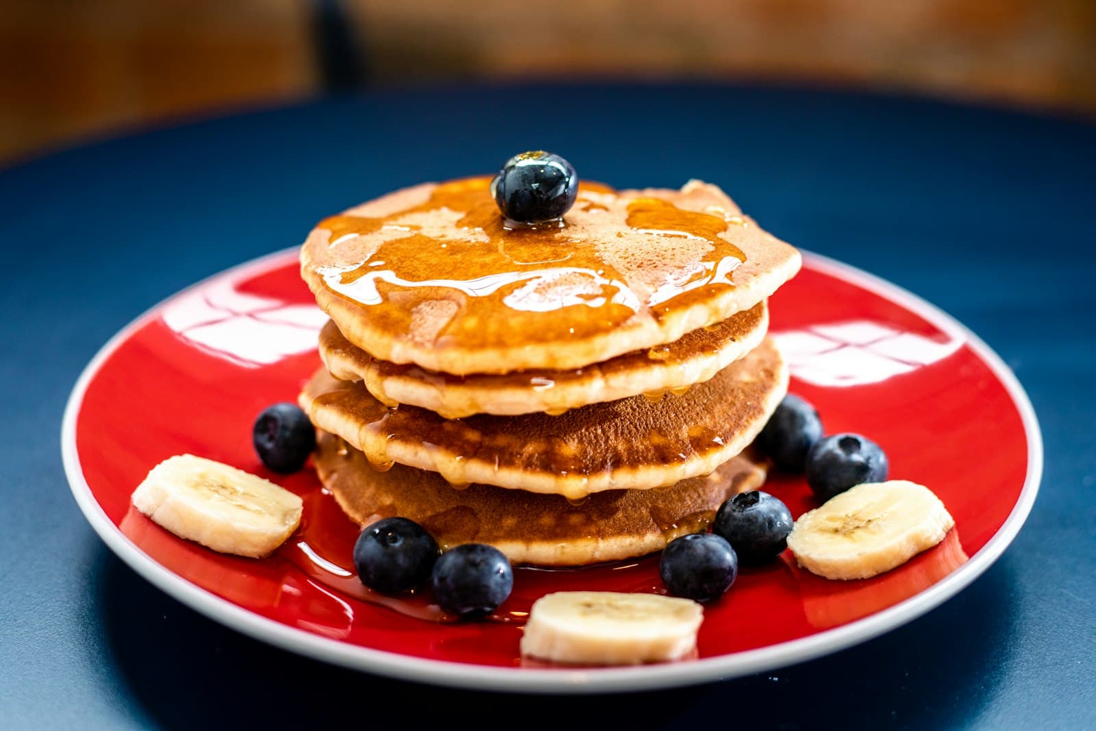 Stack of pancakes with strawberries and caramel