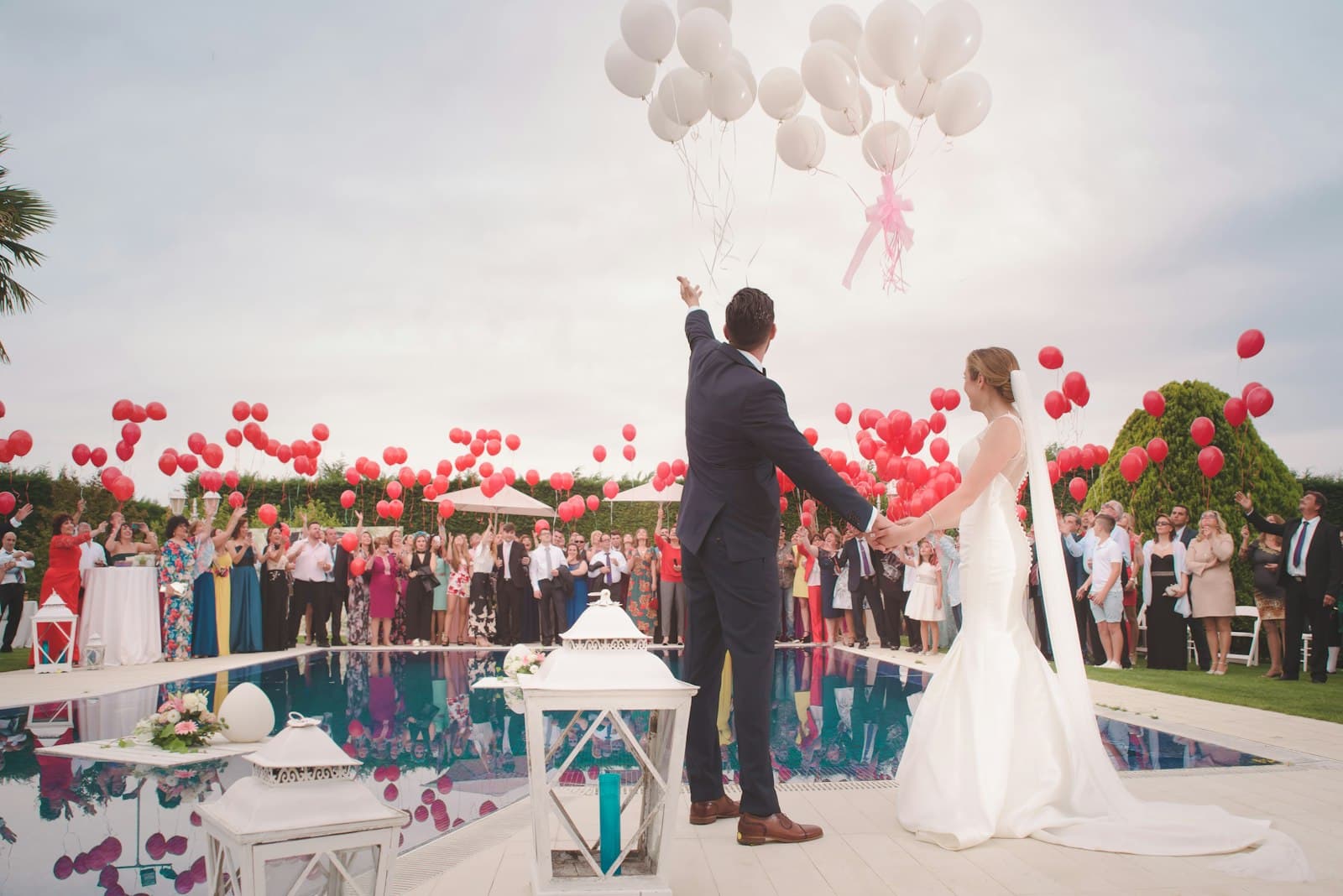 Newlyweds walking hand in hand at a beachside ceremony